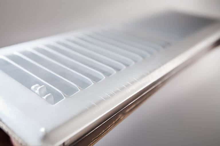 White air vent cover with angled slats.