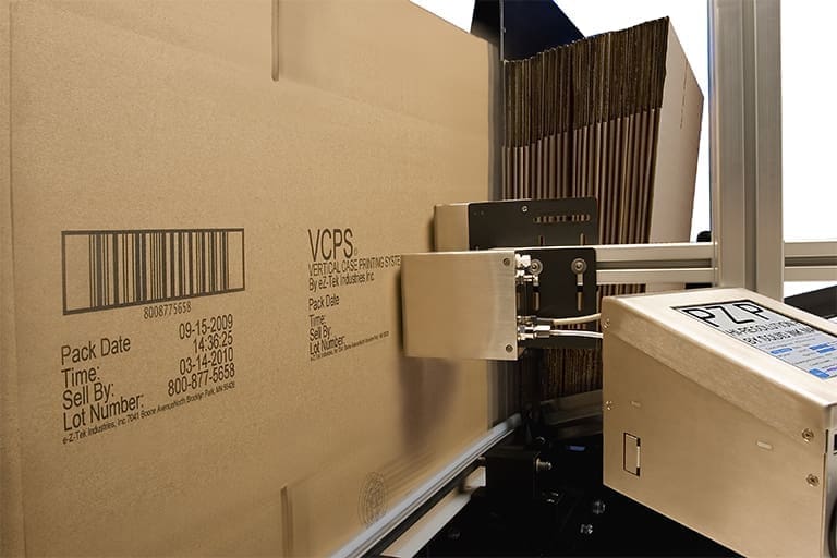 Cardboard box being labeled with barcode.