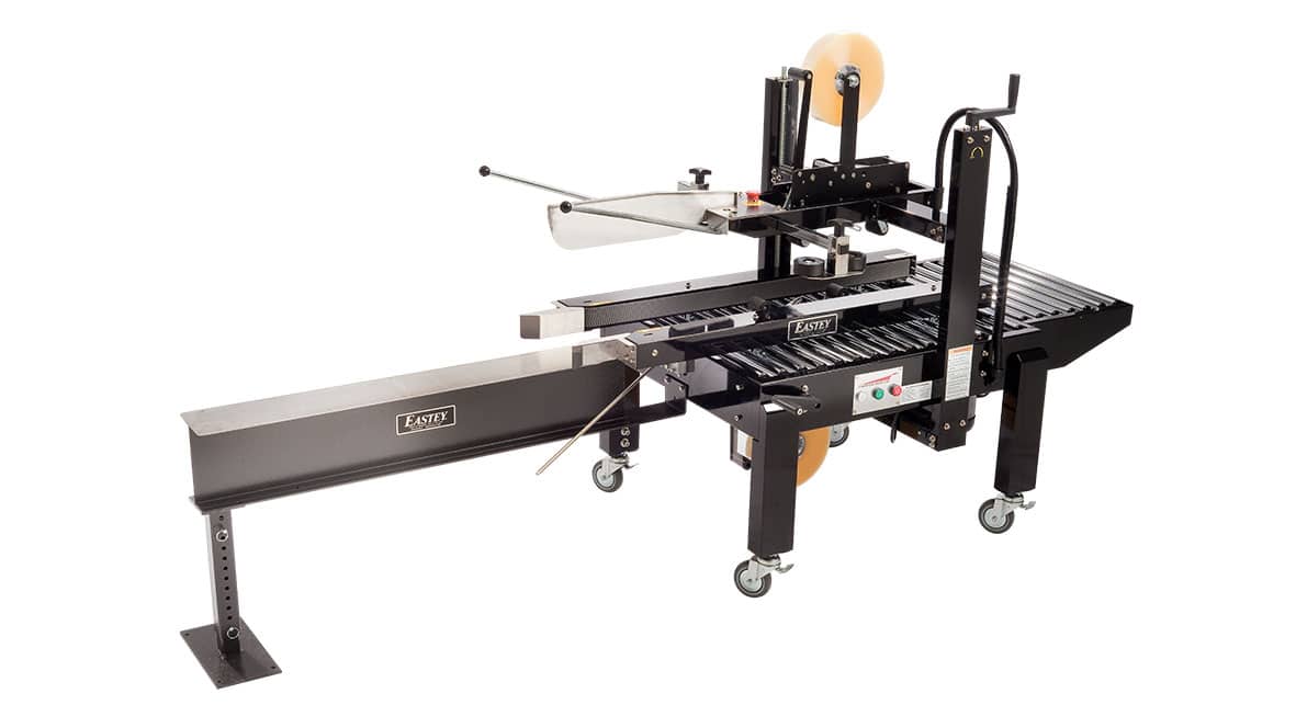 Box sealing machine on wheels, side view.
