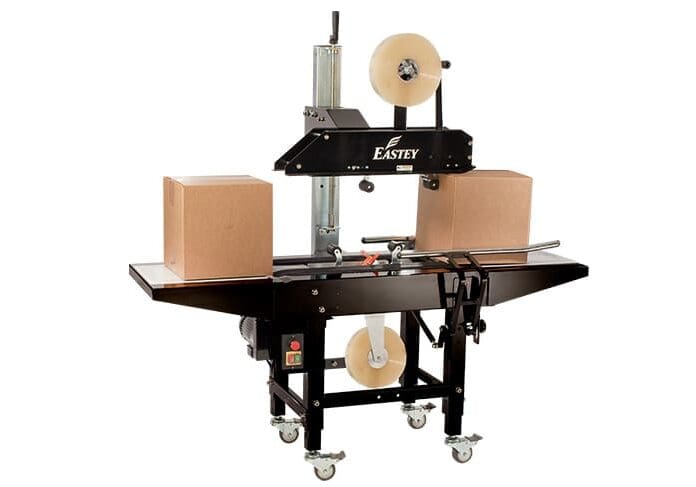 Box sealing machine with two cardboard boxes.
